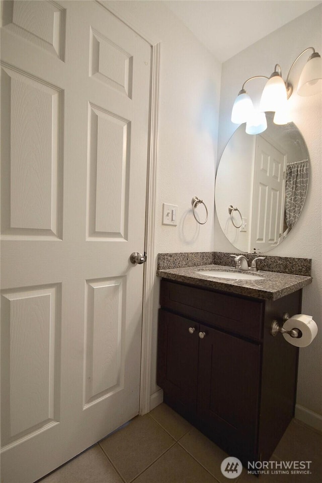 bathroom featuring tile patterned flooring and vanity