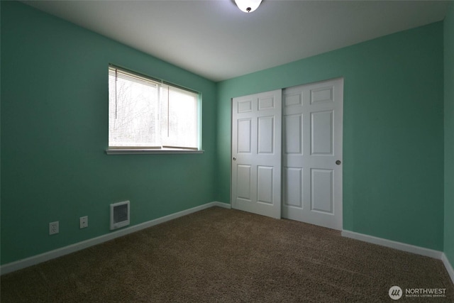 unfurnished bedroom with visible vents, carpet floors, baseboards, and a closet