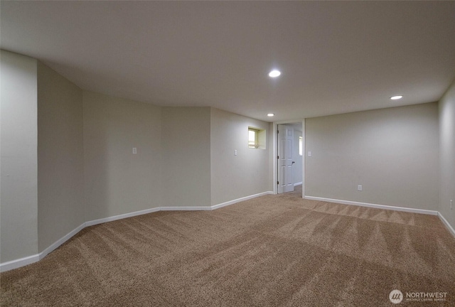 spare room featuring recessed lighting, baseboards, and light carpet