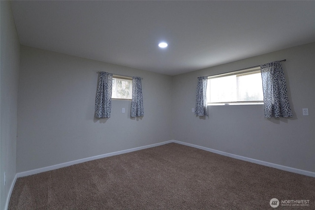 unfurnished room featuring baseboards, a healthy amount of sunlight, and carpet flooring