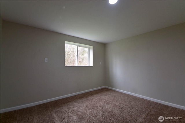 empty room with baseboards and carpet