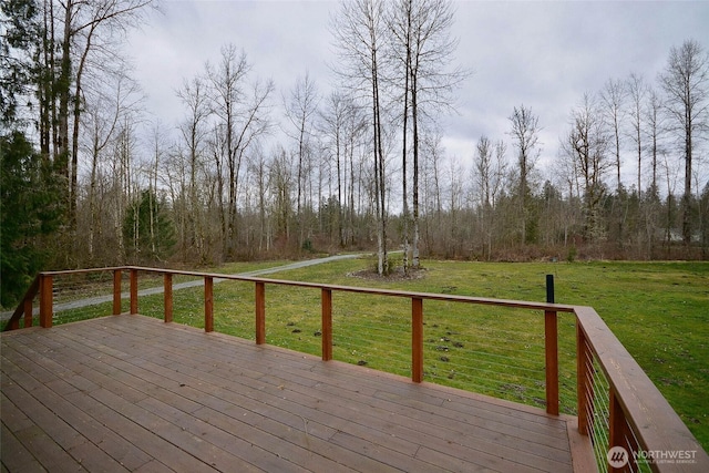 deck with a forest view and a lawn