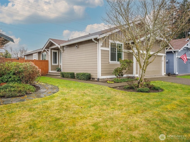 single story home with a garage, aphalt driveway, a front yard, and fence