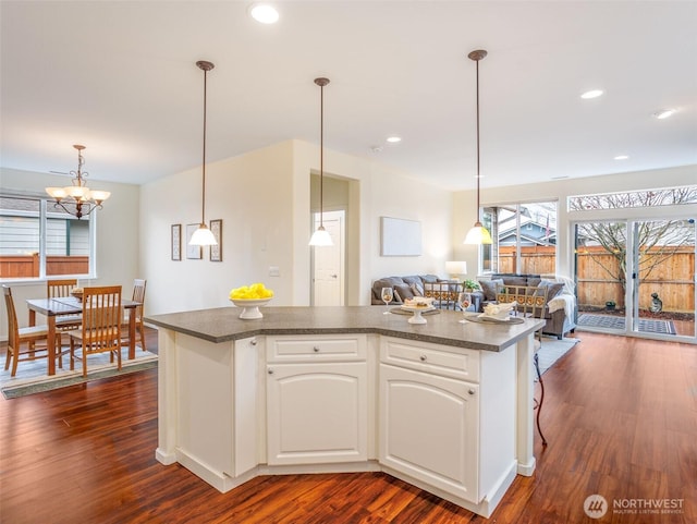 kitchen with recessed lighting, dark wood-type flooring, white cabinetry, open floor plan, and dark countertops