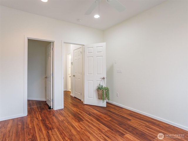 unfurnished bedroom featuring ceiling fan, baseboards, and wood finished floors