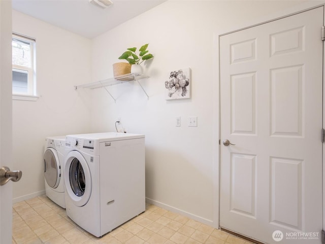 washroom with laundry area, washer and clothes dryer, and baseboards