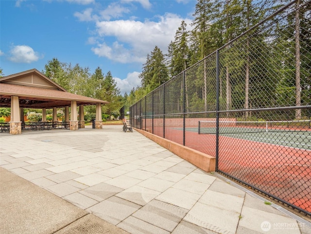 view of home's community with a tennis court, fence, and a gazebo