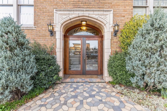 entrance to property featuring brick siding