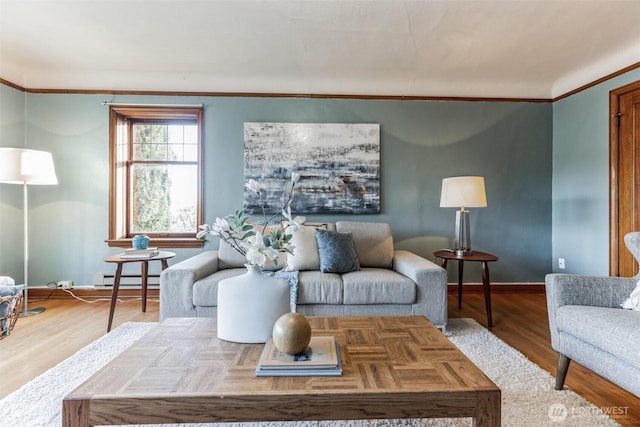 living area with baseboards, a baseboard heating unit, wood finished floors, and ornamental molding