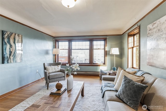 sitting room with ornamental molding, a baseboard heating unit, plenty of natural light, and wood finished floors