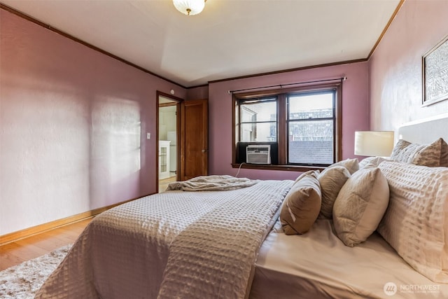 bedroom featuring cooling unit, crown molding, baseboards, and wood finished floors