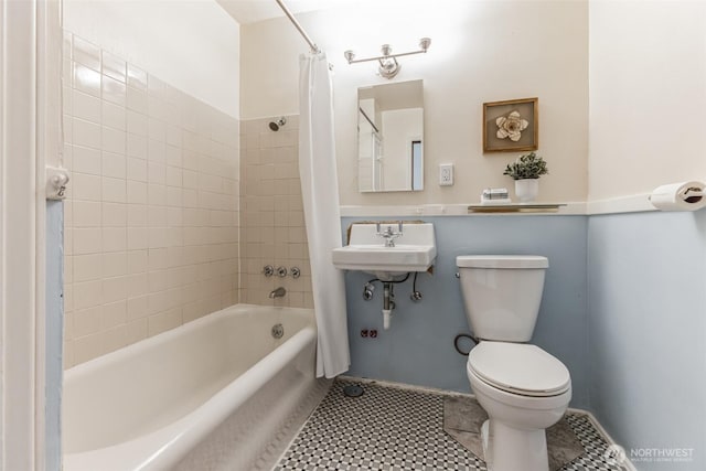 full bathroom with tile patterned flooring, a sink, shower / tub combo with curtain, and toilet