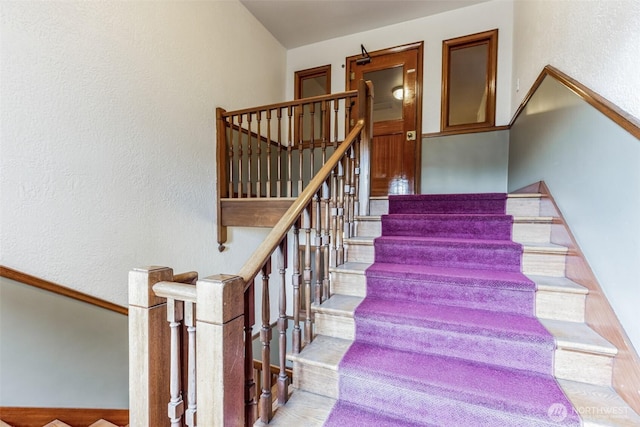 staircase with a textured wall