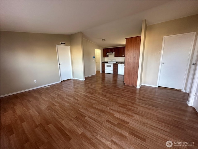 unfurnished living room with lofted ceiling, dark wood-style floors, and baseboards