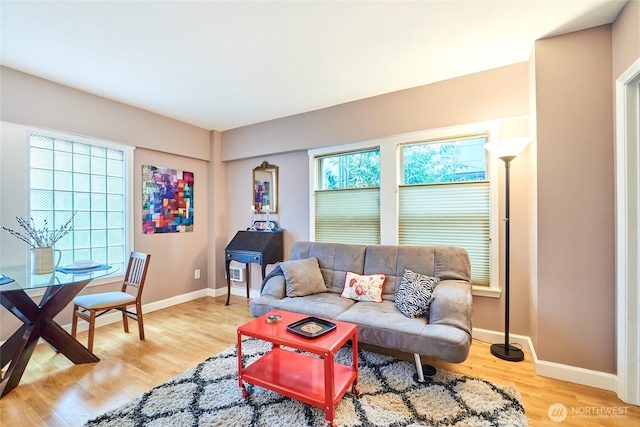 living area with light wood-style floors and baseboards