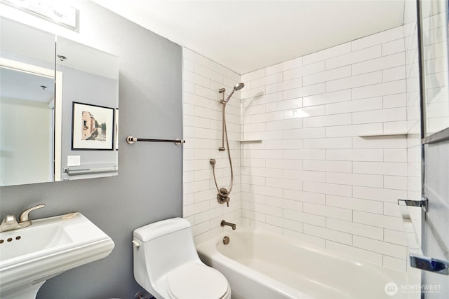 full bathroom with shower / bath combination, a sink, and toilet