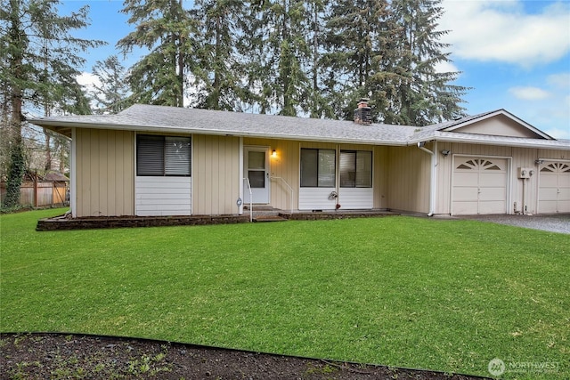 ranch-style house featuring a garage, a front yard, driveway, and entry steps