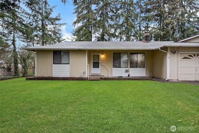 ranch-style home featuring a garage, roof with shingles, a chimney, and a front yard