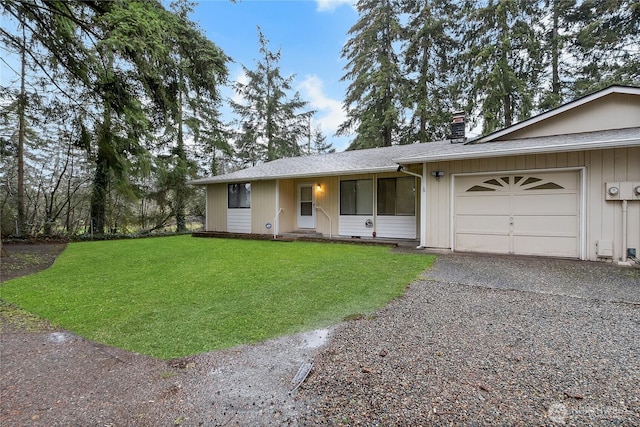 ranch-style home featuring aphalt driveway, a garage, roof with shingles, a front lawn, and a chimney