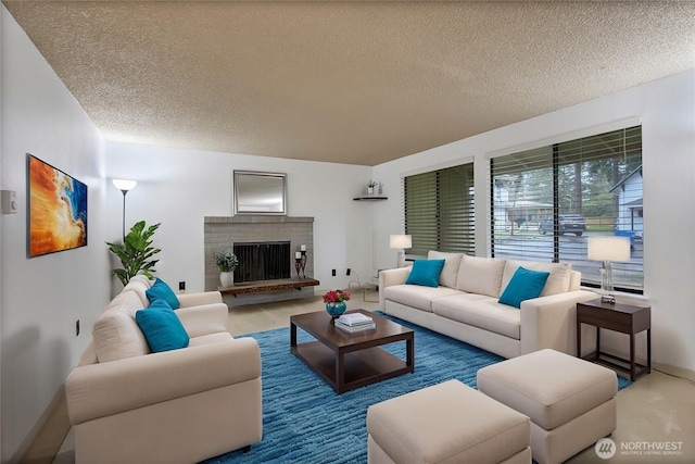 living room featuring a textured ceiling and a fireplace