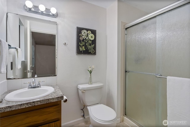 full bath featuring toilet, a shower stall, and vanity