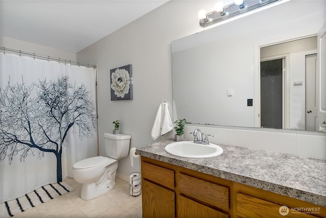 full bath with a shower with shower curtain, vanity, toilet, and tile patterned floors