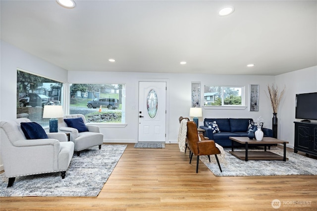 living area featuring wood finished floors, a wealth of natural light, and recessed lighting