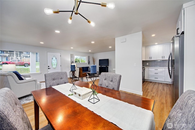 dining area with a healthy amount of sunlight, light wood-style flooring, baseboards, and recessed lighting