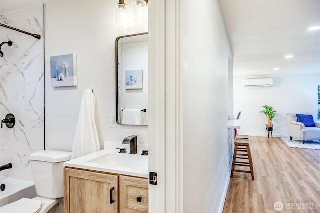 full bathroom with recessed lighting, toilet, an AC wall unit, vanity, and wood finished floors