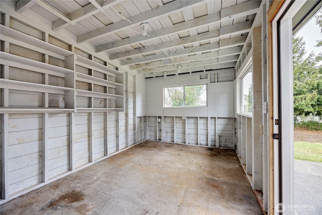 empty room with unfinished concrete flooring