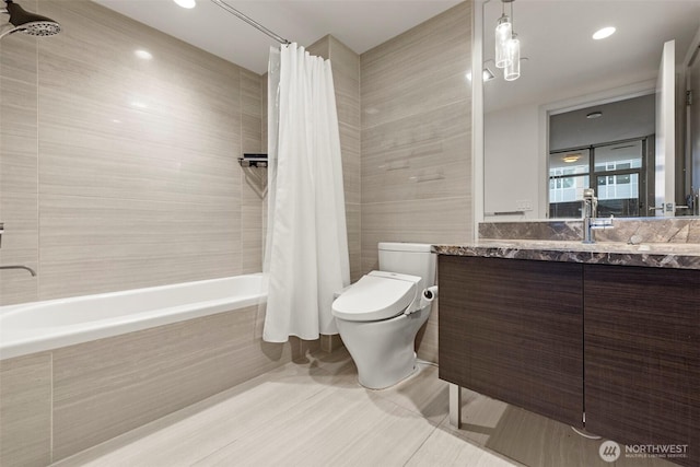 full bathroom featuring tile patterned flooring, toilet, vanity, tile walls, and tiled shower / bath