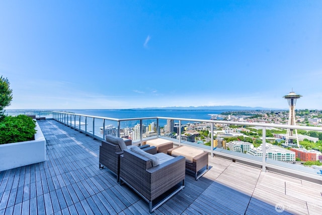 wooden deck featuring outdoor lounge area and a water view