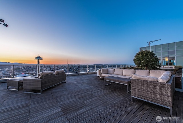 deck at dusk featuring an outdoor living space