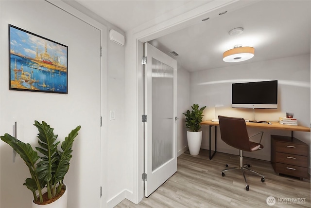 office space featuring light wood-style floors and visible vents