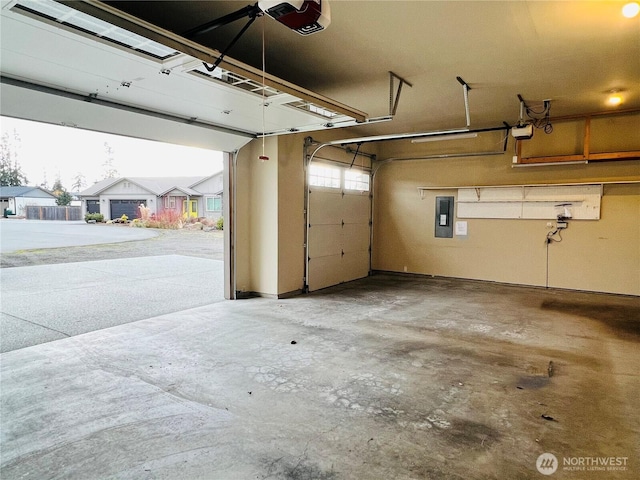 garage featuring electric panel and a garage door opener