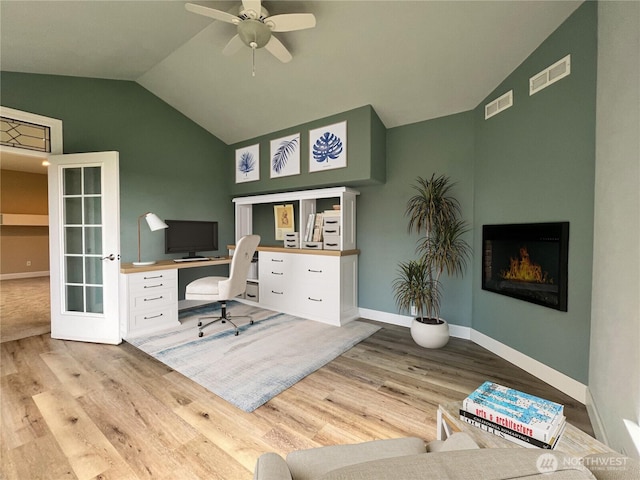 office area with visible vents, lofted ceiling, and wood finished floors