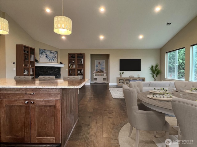 living area featuring visible vents, recessed lighting, dark wood-style flooring, and vaulted ceiling