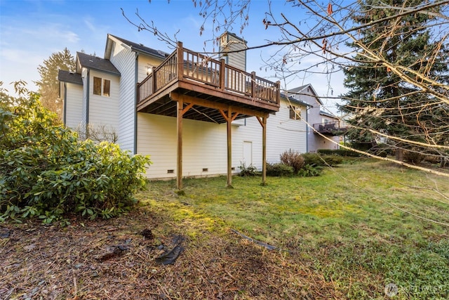 back of house featuring a yard, crawl space, and a wooden deck