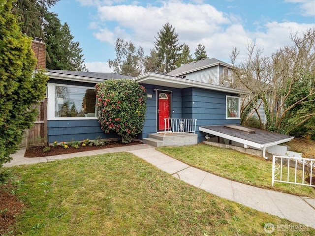 view of front of house featuring a front yard, fence, and a chimney