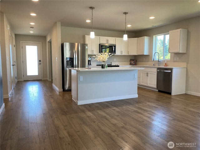3601 Page St, Port Angeles, WA 98362 - kitchen featuring stainless steel appliances, white cabinetry, dark wood finished floors, a kitchen island with sink, and recessed lighting