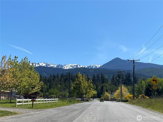 3601 Page St, Port Angeles, WA 98362 - view of asphalt street featuring a mountain view, a wooded view, and traffic signs