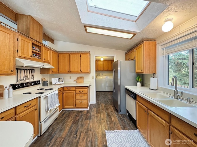 kitchen with white range with electric cooktop, dishwashing machine, washing machine and clothes dryer, under cabinet range hood, and a sink