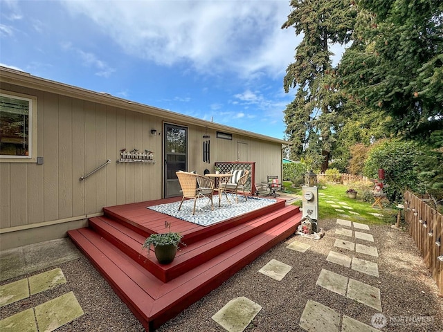 wooden terrace with fence and outdoor dining space