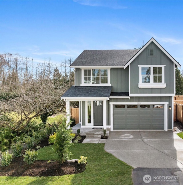 view of front of property featuring an attached garage, driveway, roof with shingles, board and batten siding, and a front yard