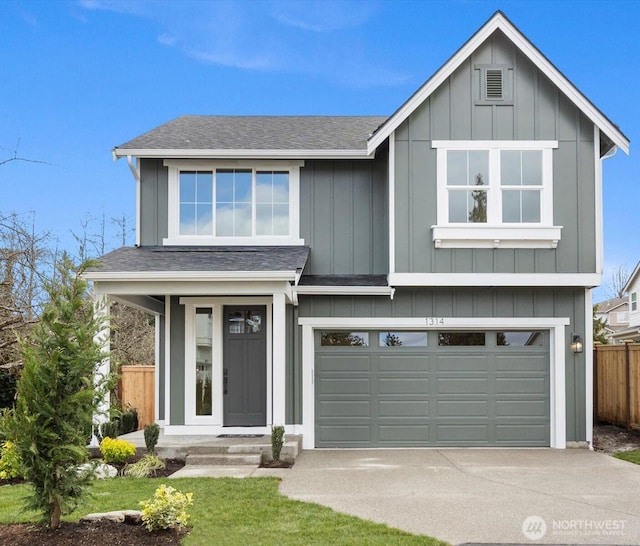 view of front of house featuring concrete driveway, board and batten siding, an attached garage, and fence