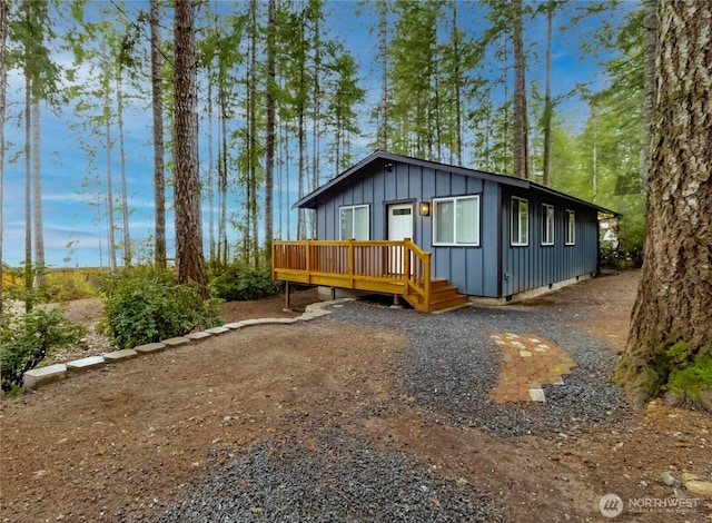 exterior space with a deck and board and batten siding