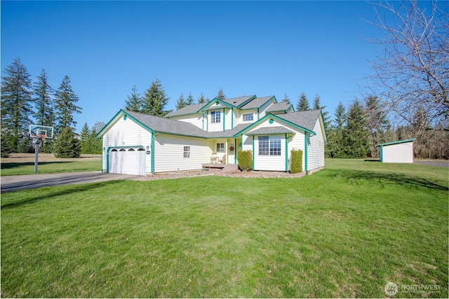 view of front of house with driveway, an attached garage, and a front yard