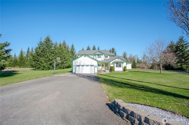 view of front of property with a front yard, driveway, and an attached garage