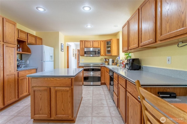 kitchen with a kitchen island, stainless steel appliances, a sink, and recessed lighting