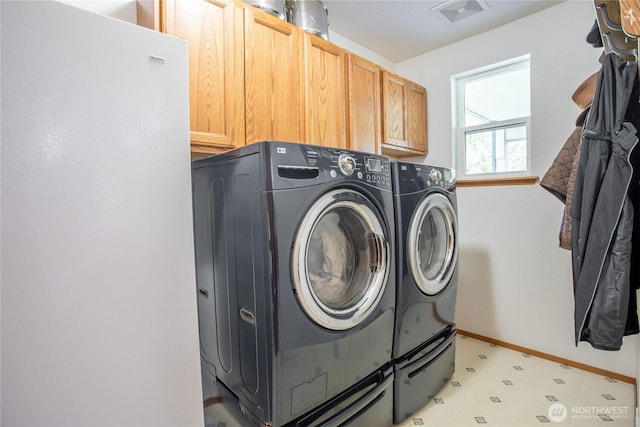 laundry area with cabinet space, baseboards, visible vents, independent washer and dryer, and light floors